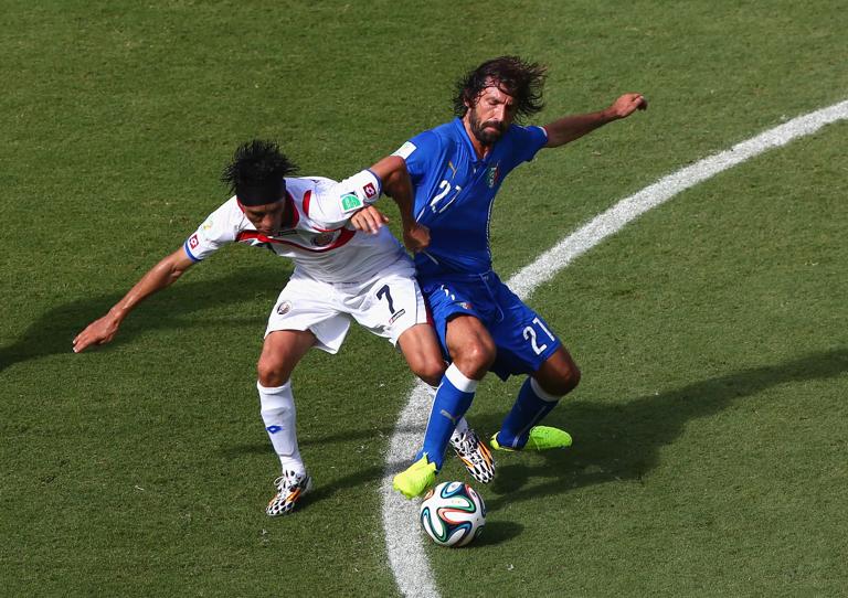 RECIFE, BRAZIL - JUNE 20: Christian Bolanos of Costa Rica and Andrea Pirlo of Italy compete for the ball during the 2014 FIFA World Cup Brazil Group D match between Italy and Costa Rica at Arena Pernambuco on June 20, 2014 in Recife, Brazil. (Photo by Michael Steele/Getty Images)