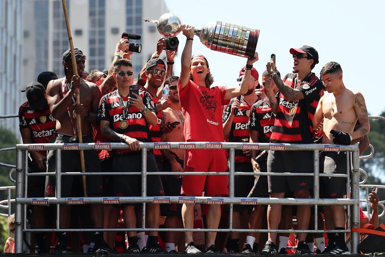 Filipe Luis and Flamengo players celebrate on a bus with the Copa Libertadores trophy