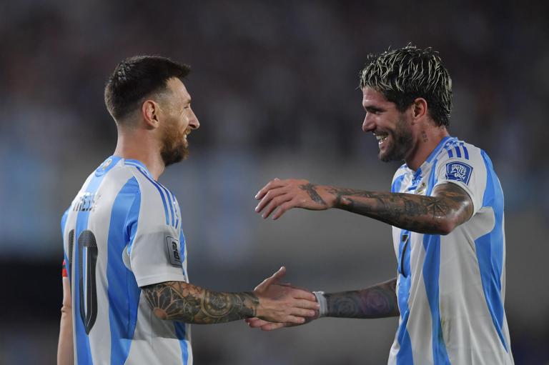 BUENOS AIRES, ARGENTINA - OCTOBER 15: Lionel Messi of Argentina celebrates with teammate Rodrigo De Paul after scoring the team's first goal during the FIFA World Cup 2026 South American Qualifier match between Argentina and Bolivia at Estadio Más Monumental Antonio Vespucio Liberti on October 15, 2024 in Buenos Aires, Argentina. (Photo by Marcelo Endelli/Getty Images)